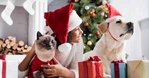 Girl, dog, and cat with Christmas decorations
