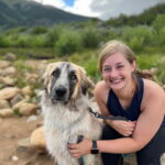 Woman outside smiling with big dog